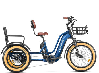 A blue and black GREATTAN electric trike with a passenger seat, front basket, and integrated lights. The trike features a single chainring and is designed for adults.