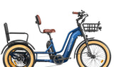 A blue and black GREATTAN electric trike with a passenger seat, front basket, and integrated lights. The trike features a single chainring and is designed for adults.